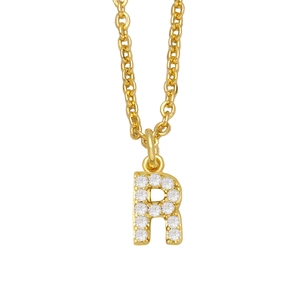 Detailed macro view of gold-plated letter R pendant necklace with sparkling zircons