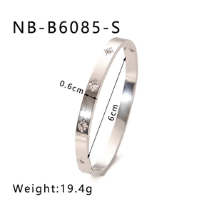 Detailed close-up of silver star-embossed titanium steel bangle with small zircon studs