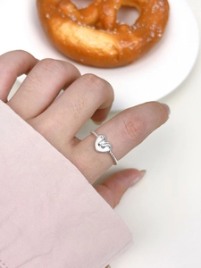 Close-up of a minimalist S925 sterling silver ring featuring a 3D heart-shaped design