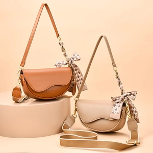Chic saddle shoulder bag with chain strap and silk scarf in tan and beige colors