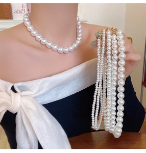Detail shot of vintage pearl necklaces in various diameters with elegant glossy finish