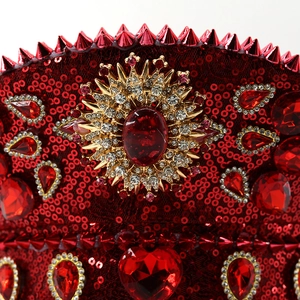 Red sequin captain hat with ruby gem, gold sunflower accents, and punk metal spikes