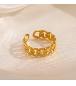 Macro shot of gold-plated chain-link adjustable ring on soft silk fabric background