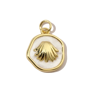Macro view of gold-plated shell pendant with white enamel filling and metal ring detail