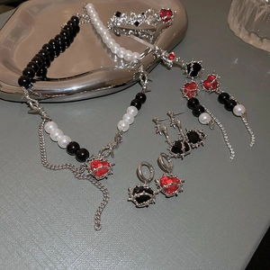 Gothic silver thorns heart earrings and pearl necklace jewelry set on metal tray