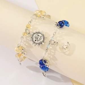 Detail of sun and moon bead bracelets for couples on a beige jewelry display stand