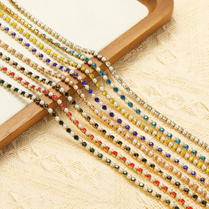 Macro detail of stainless steel chains with colorful rhinestones and imitation pearls