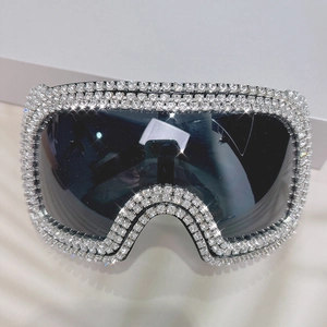Close-up of oversized punk sunglasses with sparkling rhinestones and black shield lens