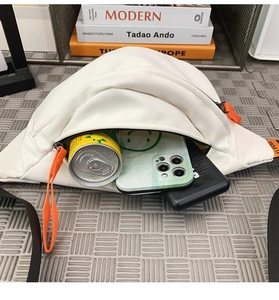 Interior view showing capacity of waterproof chest bag with phone and soda can