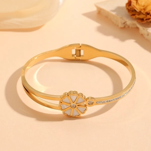 Golden stainless steel cuff bracelet with white enamel floral petals and crystal accents