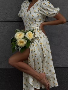 Close-up of yellow tulip floral print on white puff sleeve wrap dress with tied waist