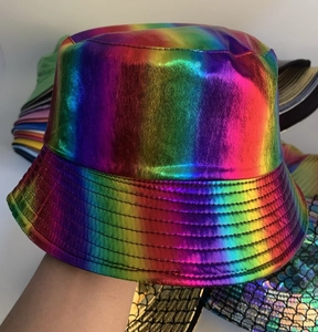 Close-up of rainbow gradient shiny bucket hat showing quilted brim details and metallic texture