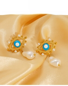 Detail of titanium steel evil eye earrings with blue enamel and baroque pearls