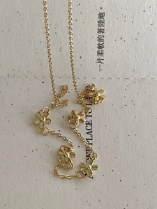 Detailed close-up of a minimalist 925 sterling silver floral necklace in gold finish