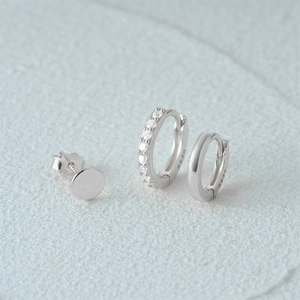 Detailed view of S925 sterling silver earring set with crystals on textured stone base
