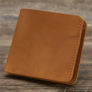 Close-up of vintage brown crazy horse leather wallet with durable waxed thread stitching