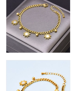 Detailed macro view of gold sunburst sunflower pendants and beads on a chain
