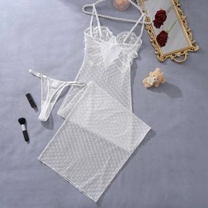 Detailed view of white heart lace lingerie set with dress and thong on flat lay background