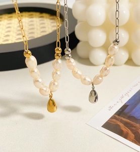 Detail of gold and silver waterdrop pendants on irregular freshwater pearl necklaces