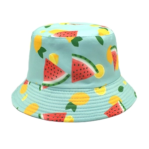 Detailed view of light blue reversible cotton bucket hat with watermelon and lemon patterns