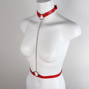Red leather body harness with metal chains and O-rings shown on a female mannequin