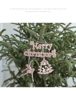 Pink glitter Merry Christmas letter and ballerina ornaments on a green Christmas tree
