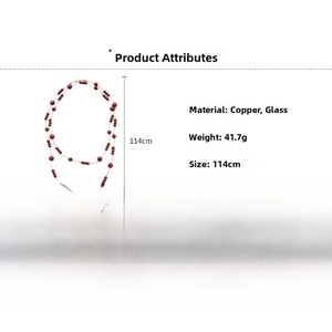 Detailed view of 114cm long red bead and copper chain necklace with product measurements