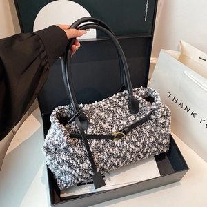 Vintage black and white tweed tote bag with leather handles in a gift box setup