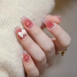 Pink blush gradient press-on nails with 3D bows, hearts and pearls decoration