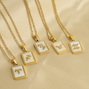 Five 18K gold-plated zodiac necklaces with rectangular shell pendants on silk background