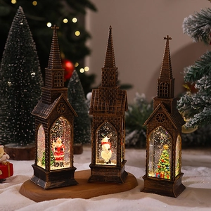 Three bronze church-shaped Christmas lanterns featuring Santa, snowman, and glowing LED snow