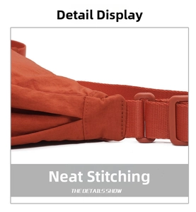 Detail of brick red fabric bag with neat stitching and durable nylon strap buckle