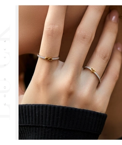 Detail of s925 silver ring featuring gold infinity and heart symbols with pavé stones