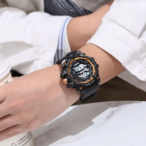 Black sport watch with rose gold bezel and digital display on wrist holding coffee