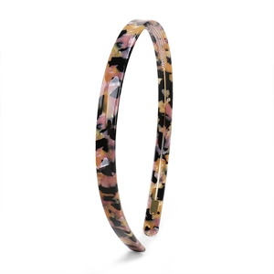 Detail showing the inner teeth and glossy acetate pink tortoiseshell pattern on hairband