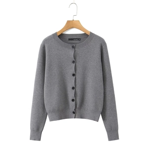 Detail of grey knitted cardigan with round neck and black buttons on a hanger