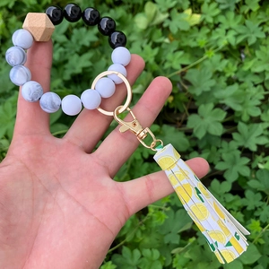 Detail of printed lemon tassel and marble beads on a DIY beaded wristlet keychain