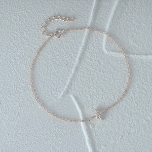 Detail of S925 sterling silver bracelet with star charm and lobster clasp closure