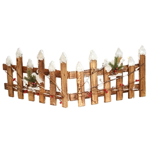 Rustic brown wooden Christmas fence with artificial snow, pine needles and red berries