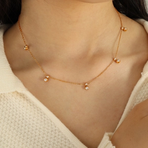 Elegant gold choker necklace with six sparkling zircon charms on a delicate chain