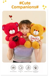Detail of plush teddy bears with embroidered hearts held by a model in a cozy setting