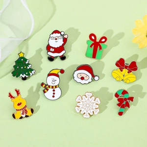 Detailed flat lay of Christmas enamel pins featuring Santa, reindeer, and snowflakes