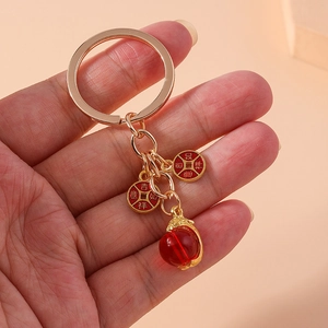 Bamboo style keychain with lucky charms and red beads in traditional Chinese design