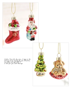Detailed view of glass painted Christmas ornaments featuring Santa Claus and tree