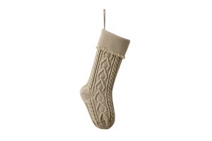 Detail view of khaki knit Christmas stocking with heart pattern and hanging tassels