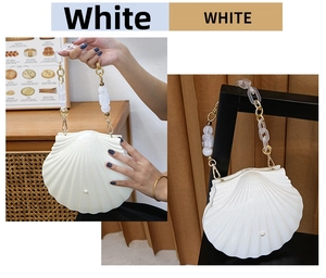 Detailed view of white shell-shaped evening bag with pearl accent and acrylic chain handle