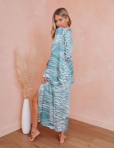Detail of teal wave pattern satin robe featuring long sleeves and elegant side slit