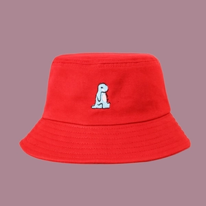 Detailed close-up of a red cotton bucket hat featuring a blue dinosaur embroidery