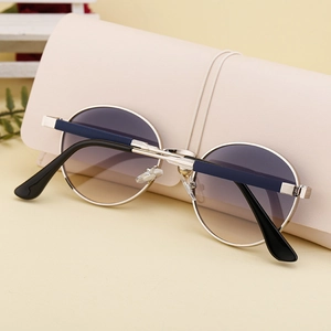 Detail of round metal sunglasses with blue gradient lenses and silver frame on case