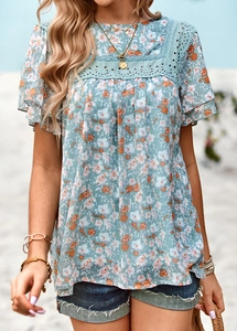 Detail of floral print top featuring lace patchwork sleeves and an elegant square neckline